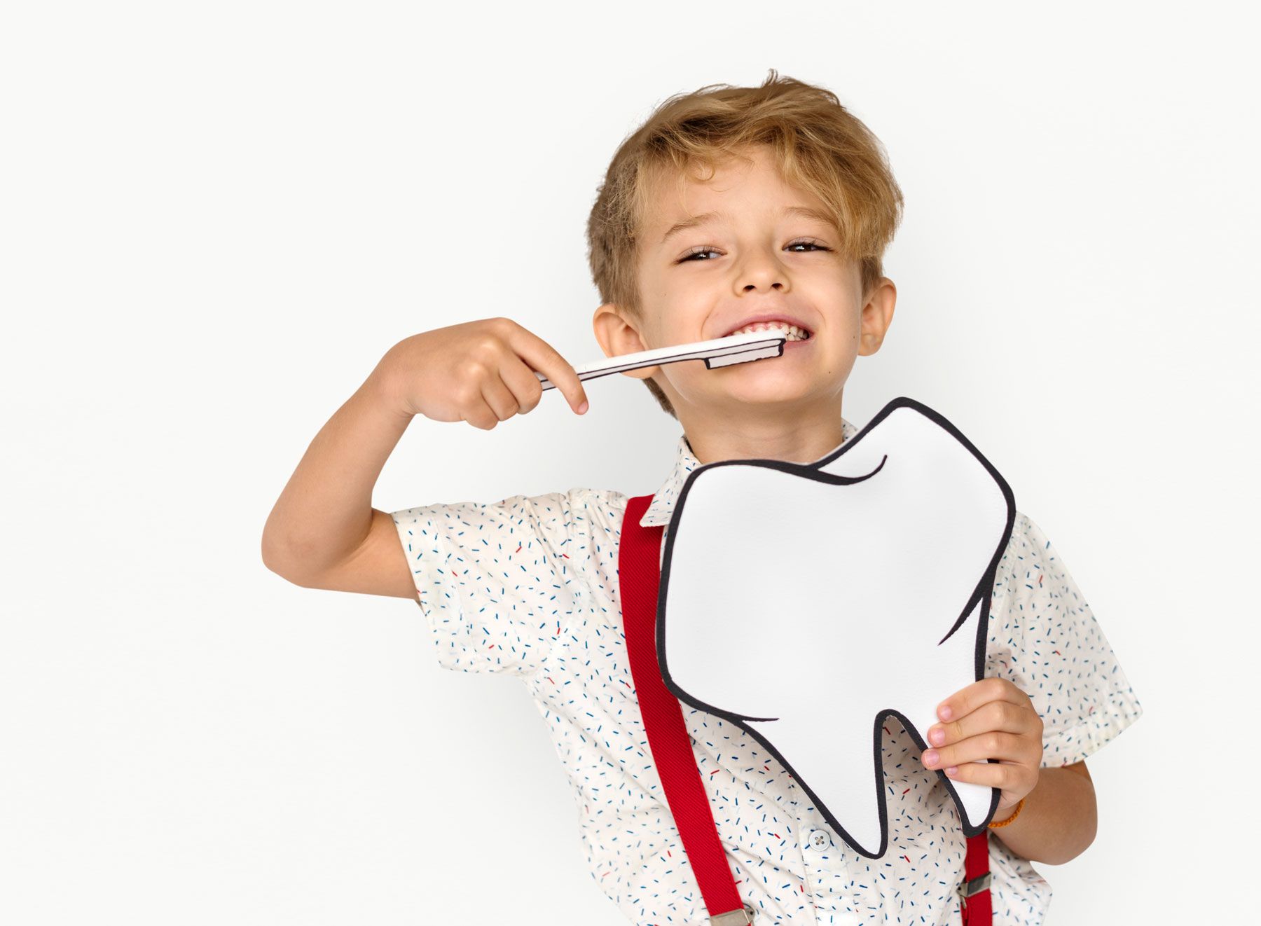 little-boy-brushing-teeth-holding-papercraft-tooth cuántos dientes tenemos